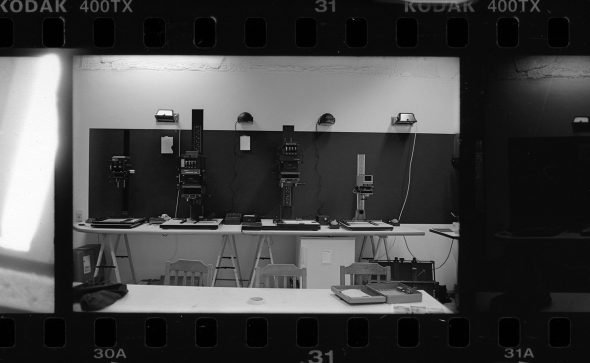 Four enlargers, four red lights